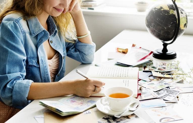 Young woman writing in diary