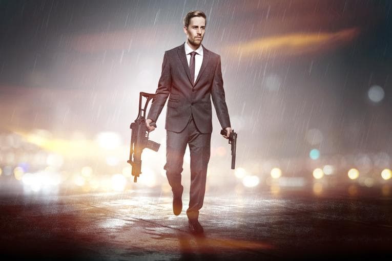 Action movie man holding two guns in the rain