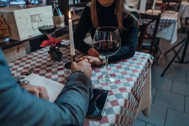 Couple holding hands at restaurant