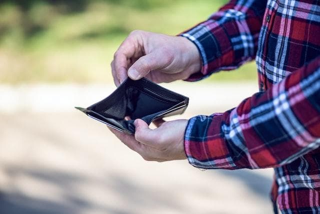 Man holding empty wallet