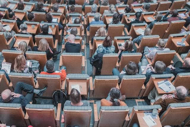 People sitting in lecture theatre from above