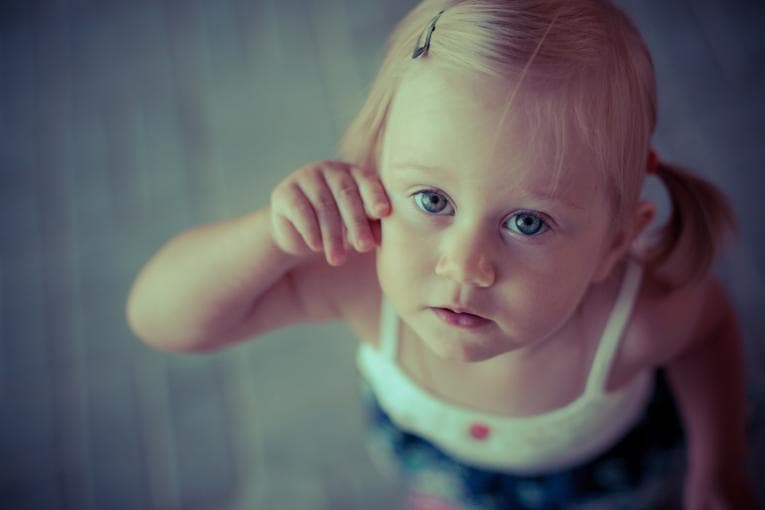 Small child looking up at camera