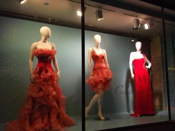 Three mannequins wearing red dresses