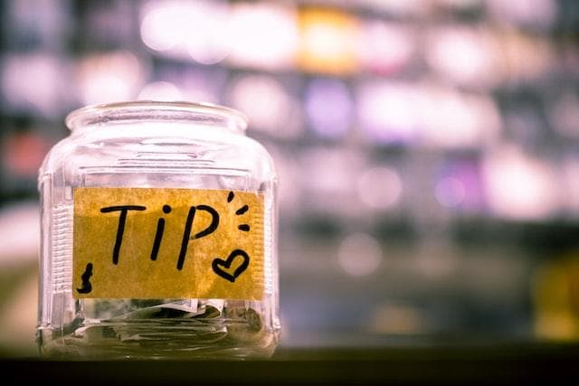 Tip jar in front of blurred background.