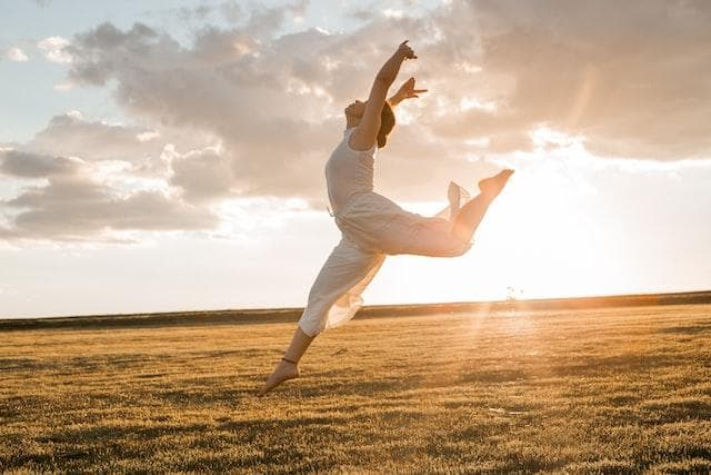 Woman dancing in field