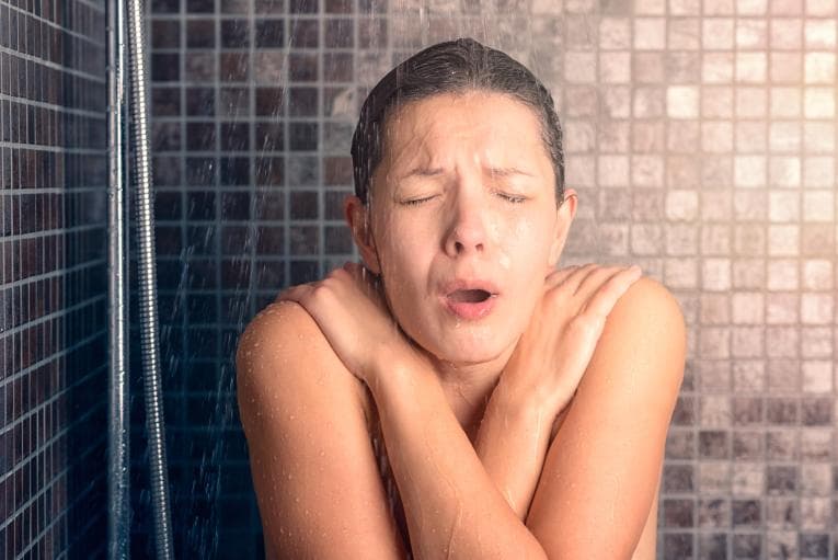 Woman having cold shower