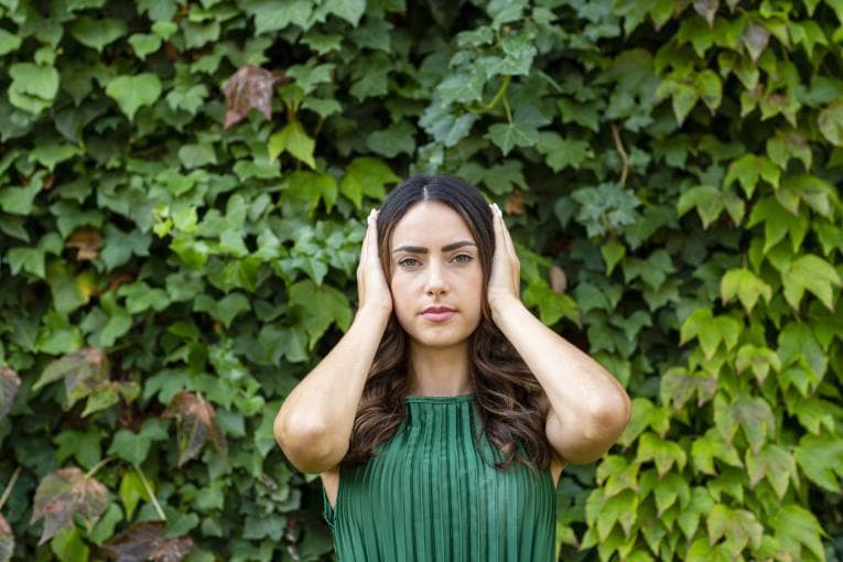 Woman with her hands over her ears