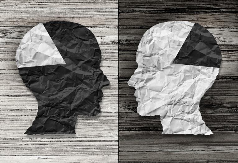 Graphic of two heads with quadrant of their brains in black and white