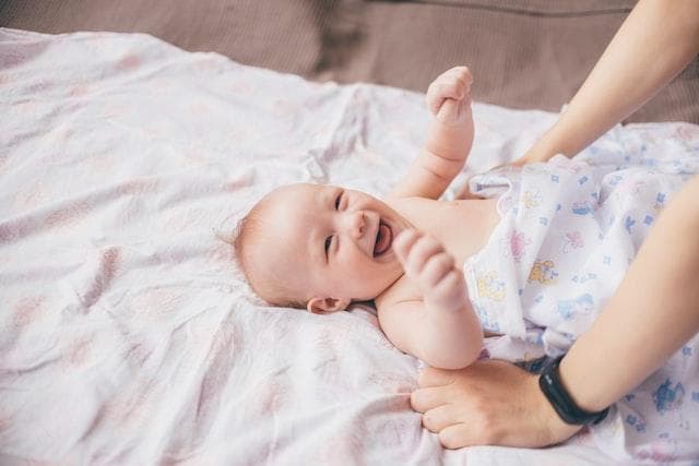 Baby smiling at parent