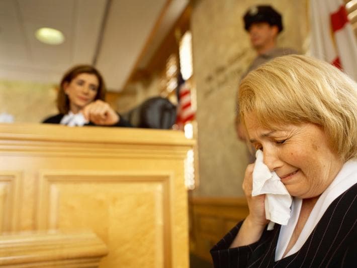 Person crying in courtroom dock