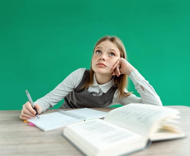 Girl daydreaming while studying