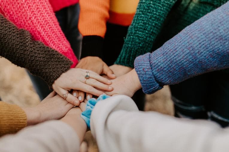 Hands piled together in solidarity