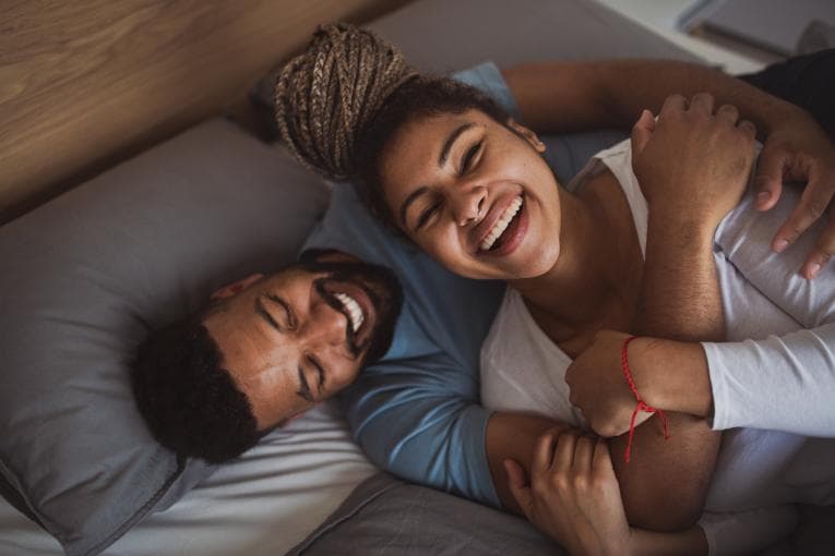 Happy couple in love laughing together