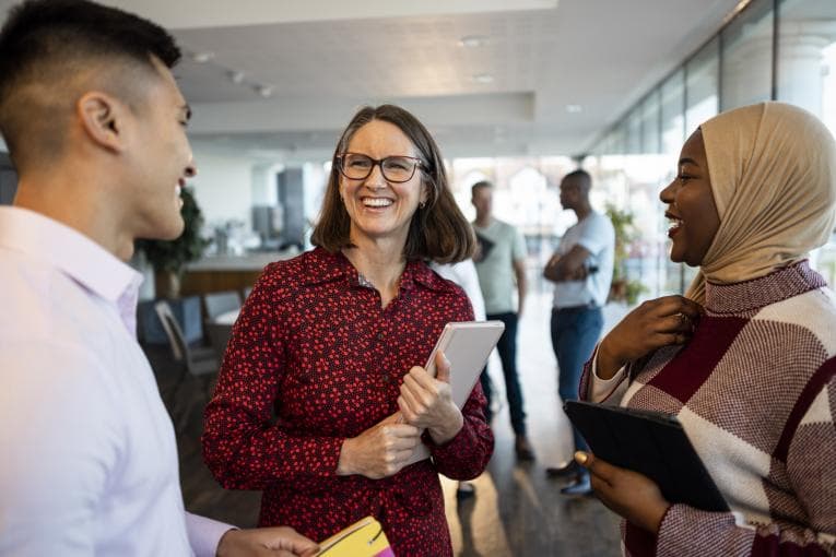 group of people smiling together in work environment