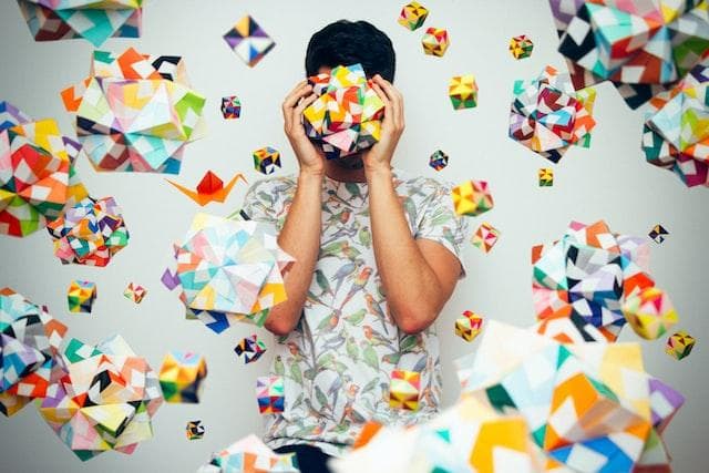 Man surrounded by geometric models