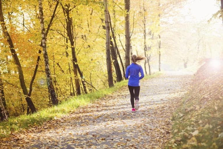 Person running on a track in woods