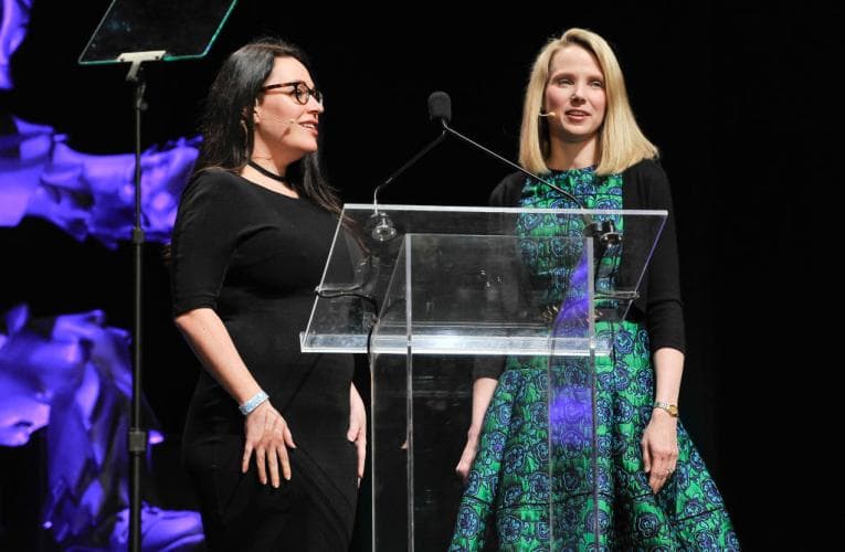 Two people standing behind a podium