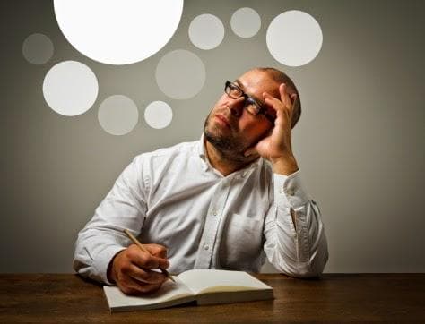 Man at a desk with round lights around their head