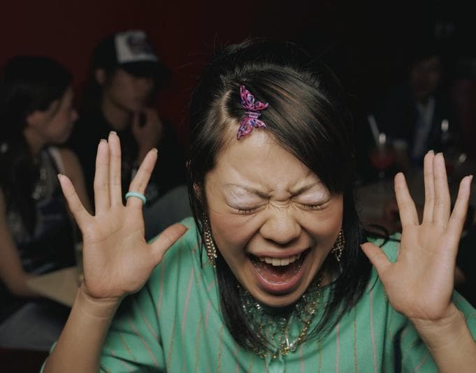 Woman laughing with hands in air