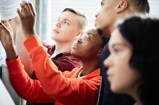 young people reading exam results