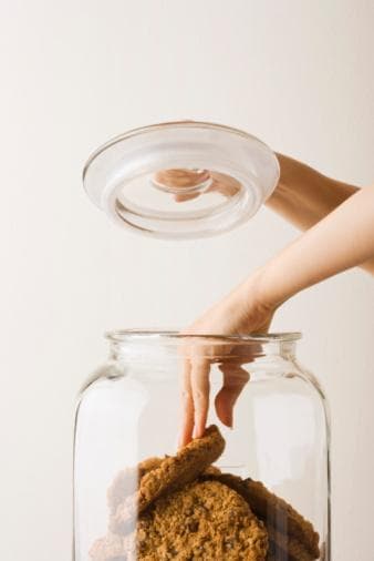 Hand reaching for Cookies in a jar