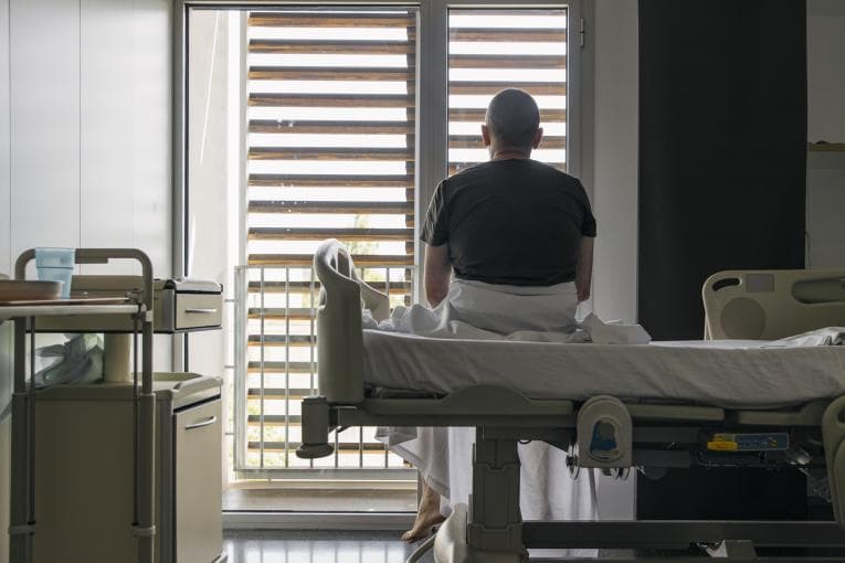 Man sitting on hospital bed