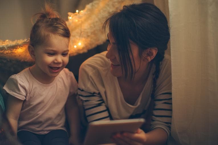 Mother reading e-book with young child