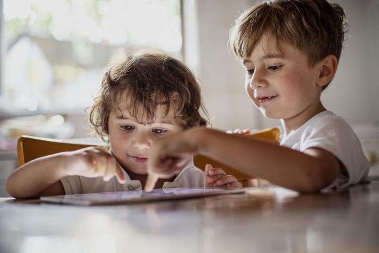 Two children using a tablet device