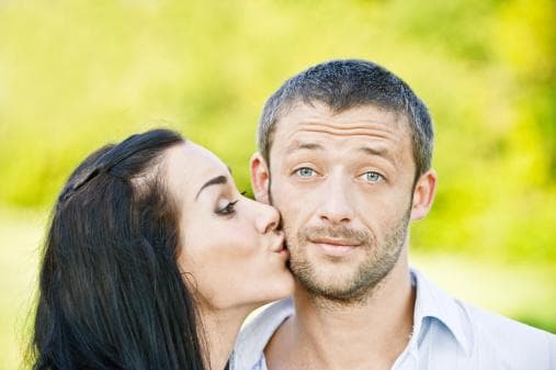 Woman kissing man on cheek