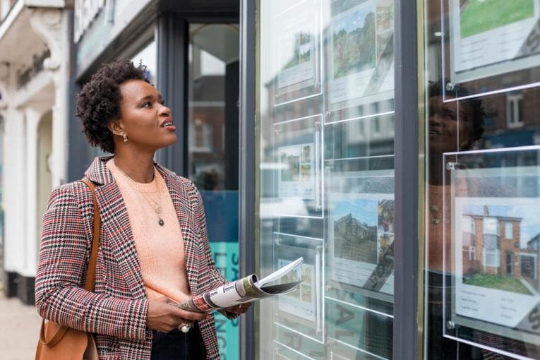 woman looking at estate agency properties