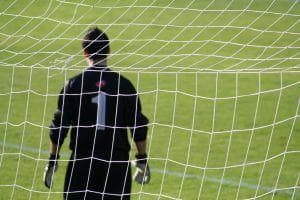 Goalkeeper standing in a goal post