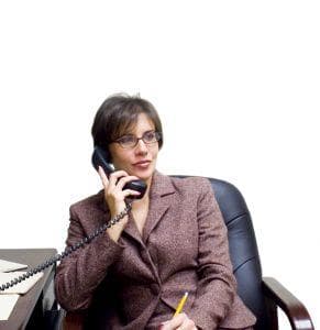 Woman in business suit holding a telephone to her ear