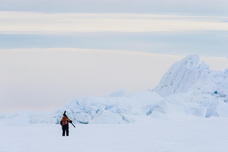 Person standing alone in Antarctic landscape