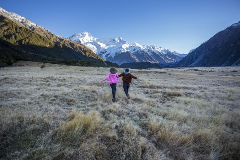 Children running through awe-inspiring landscape