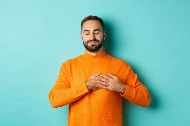 Man with hand on heart and eyes closed