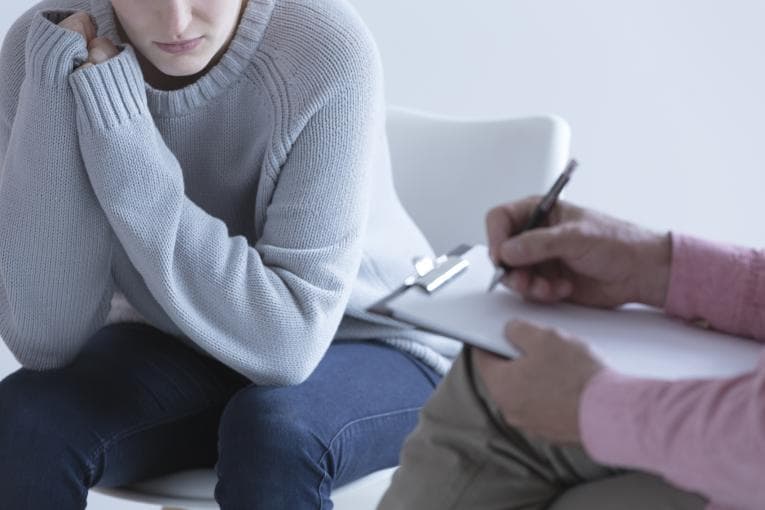 young girl sitting taking part in a counselling session