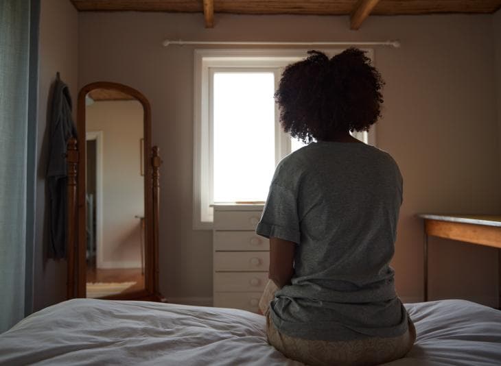 Woman looking out of the window from behind