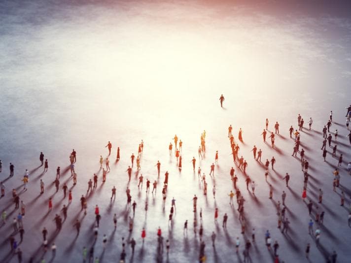 Crowd of people moving towards the horizon