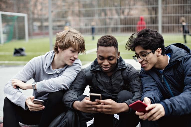 Teenage boys looking at phone