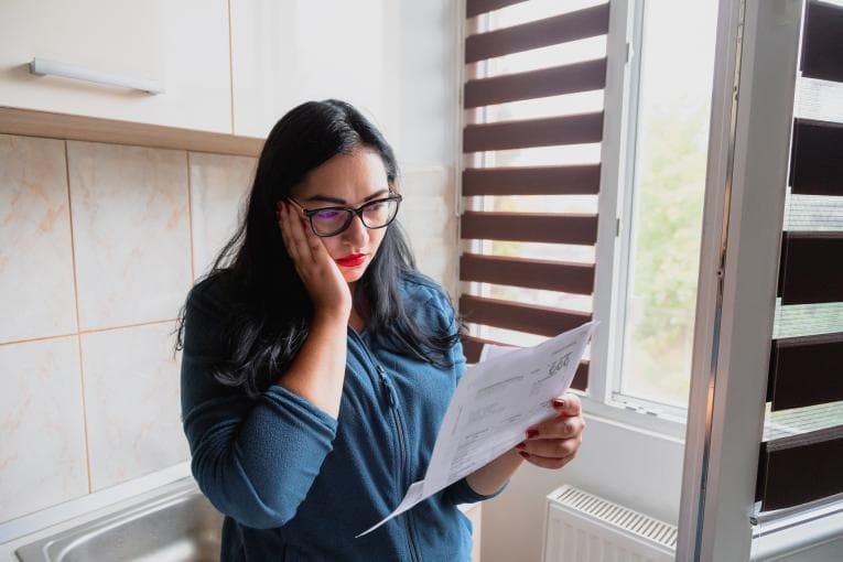 Worried woman looking at bills