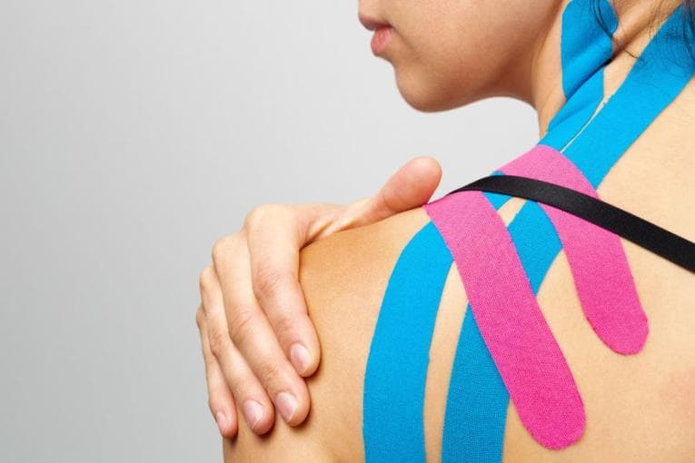 Person with hypermobility showing physio tape on shoulder