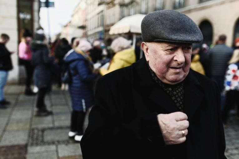 Man standing alone in a crowd