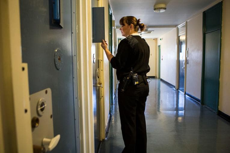 Prison officer checking cell