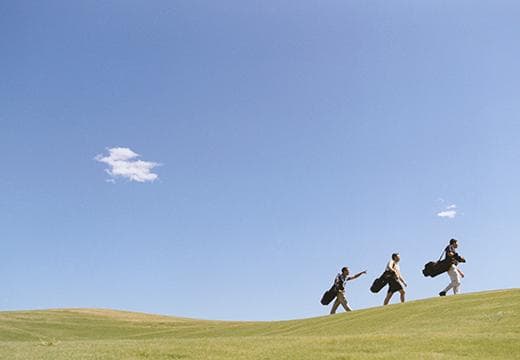 Golfers walking the course