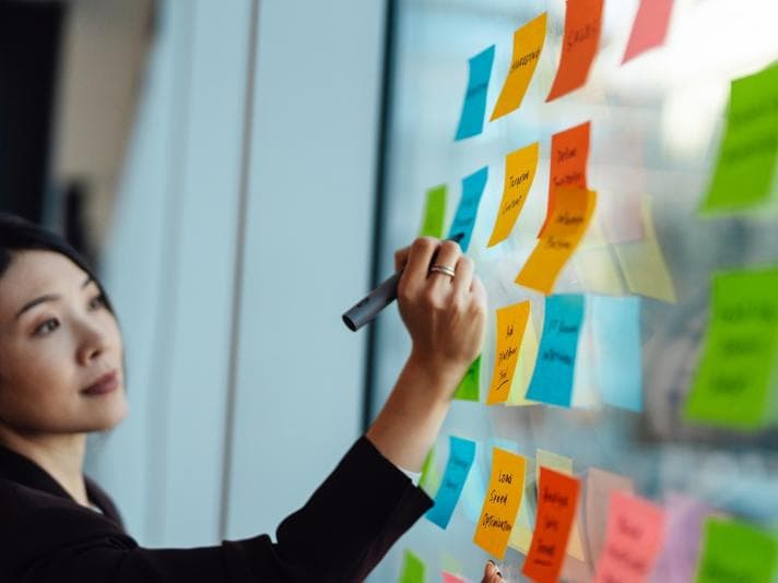 Woman writing on post-its