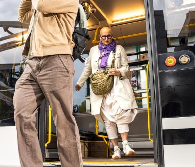 Woman getting off bus