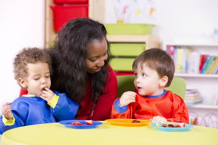 Children at nursery eating fruit