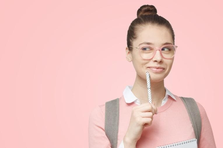 Smiling fresher student in pink on a matching background