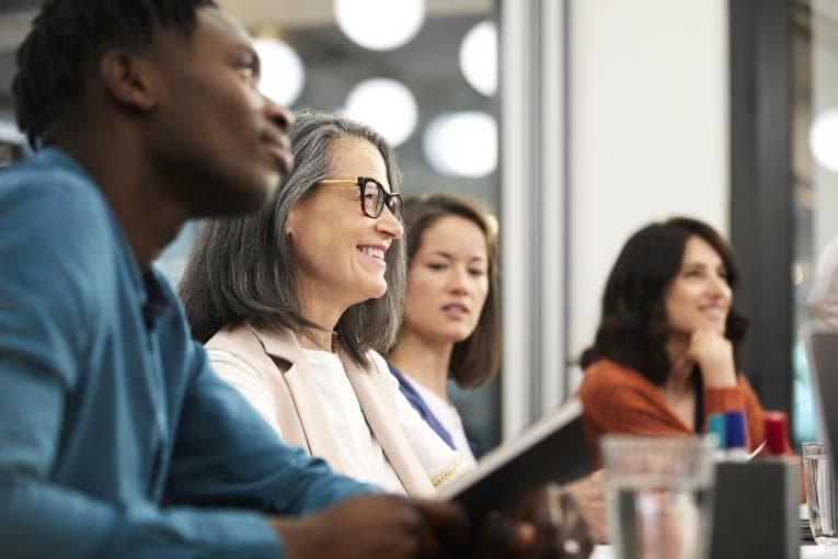 People smiling around a table