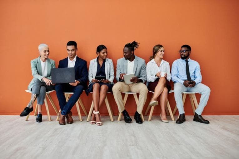 Line up of job candidates on orange background